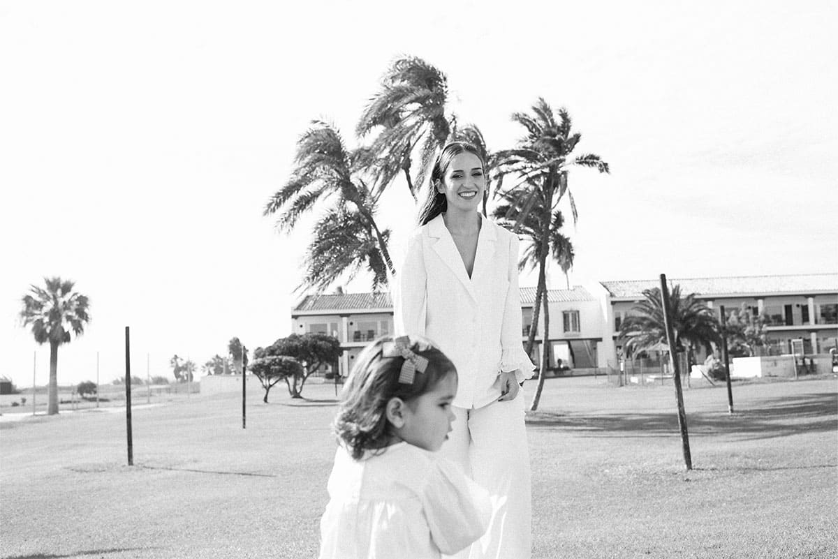 A woman and a child walk together in a serene outdoor setting
